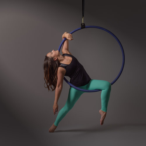 A woman holds a hoop on a pole