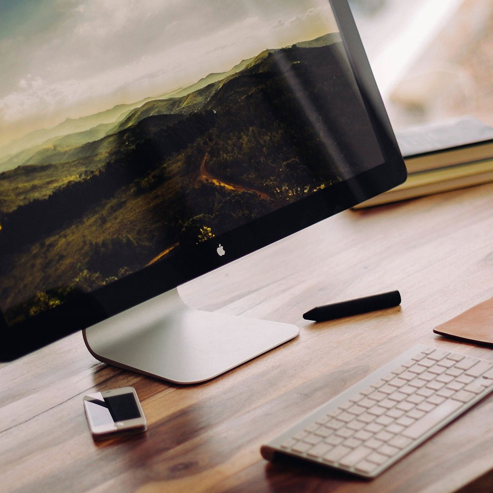 A desktop mac with a keyboard.